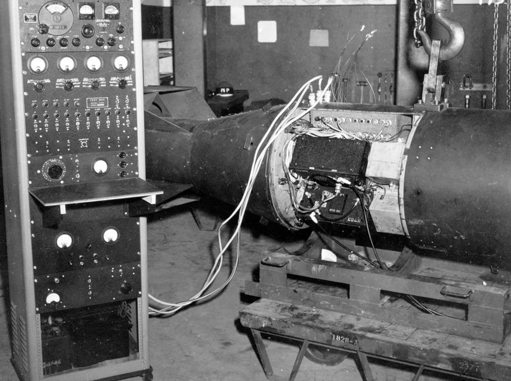 A Little Boy unit on Tinian connected to test equipment, possibly to test or charge components within the device. 